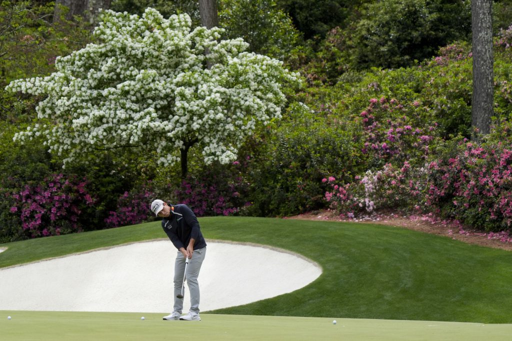 viktor hovland putting on hole 13 at augusta national ahead of the masters