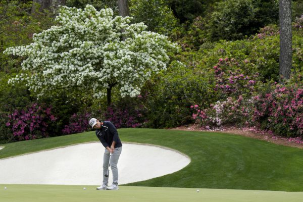 viktor hovland putting on hole 13 at augusta national ahead of the masters